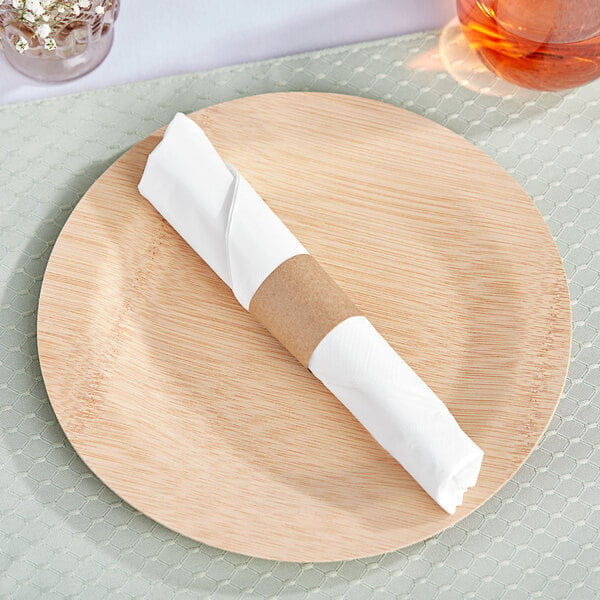 A wooden plate with a Choice white napkin wrapped in a brown paper napkin band.