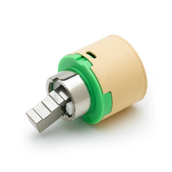 A small round green and white ceramic cartridge with a metal tip.