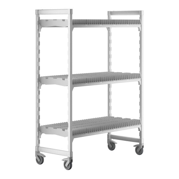 A white plastic Camshelving® drying rack cart with three shelves on wheels.