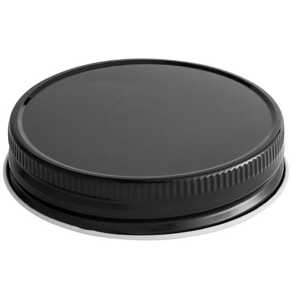 A black metal lid with a silver rim.
