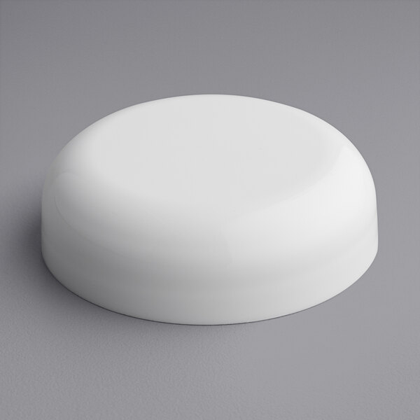 A white round 58/400 continuous thread dome lid on a gray surface.