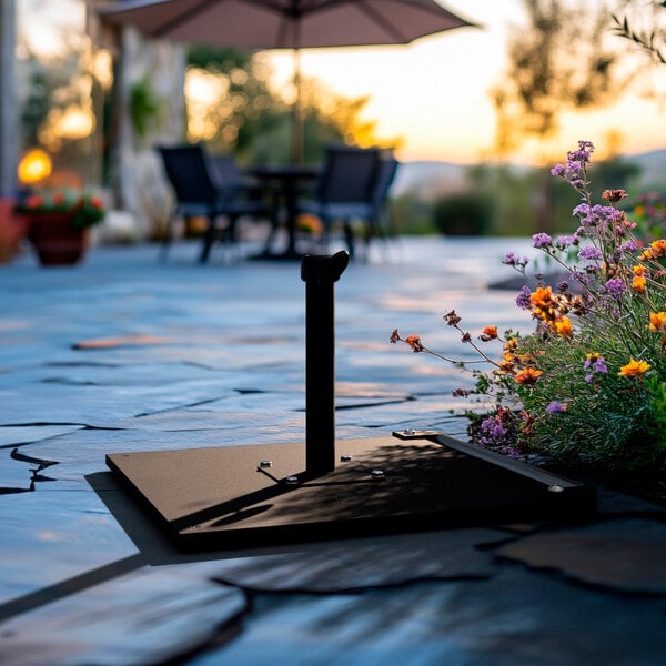 A black steel umbrella base with a caster, designed to support outdoor umbrellas.
