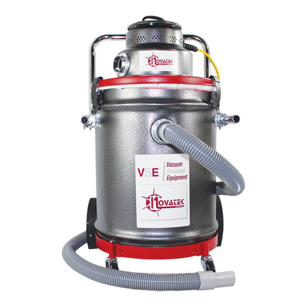 A white Novatek industrial floor vacuum with hose attached.