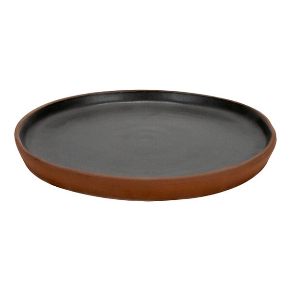 A black stoneware plate with a brown rim.