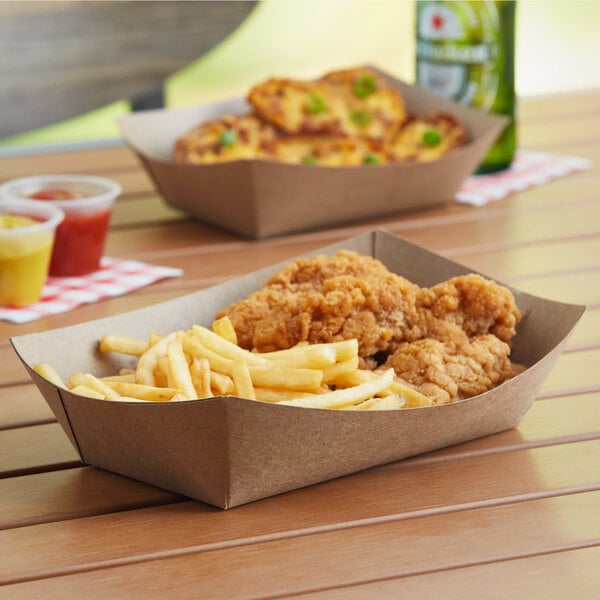 A tray of fried chicken and french fries on a table in a farm-to-table restaurant.