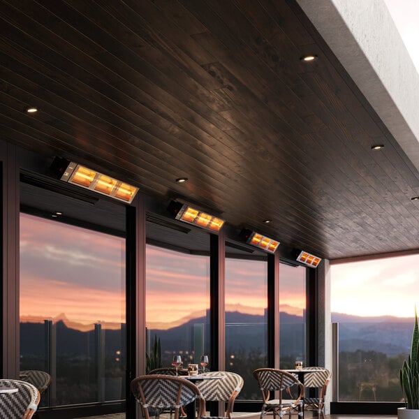 A commercial patio with tables and chairs and a Boltic black electric infrared heater.