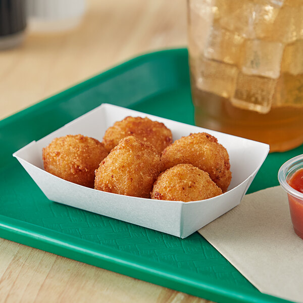 A white paper food tray of fried food with a drink.