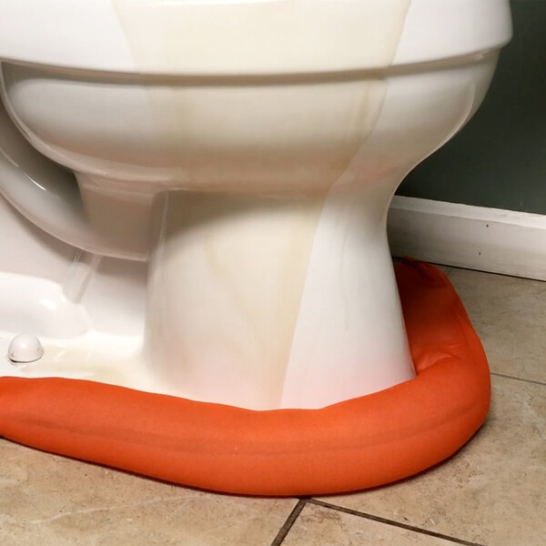 A white toilet with a Quick Dam water barrier with an orange border.
