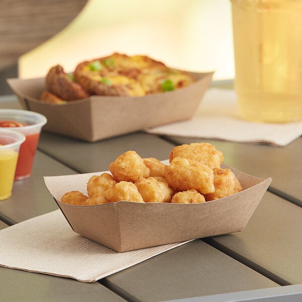 A table with Southern Champion paper trays of food and drinks.