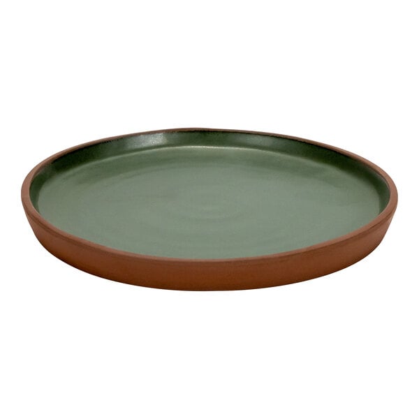 An Arcoroc green stoneware plate with a brown rim.