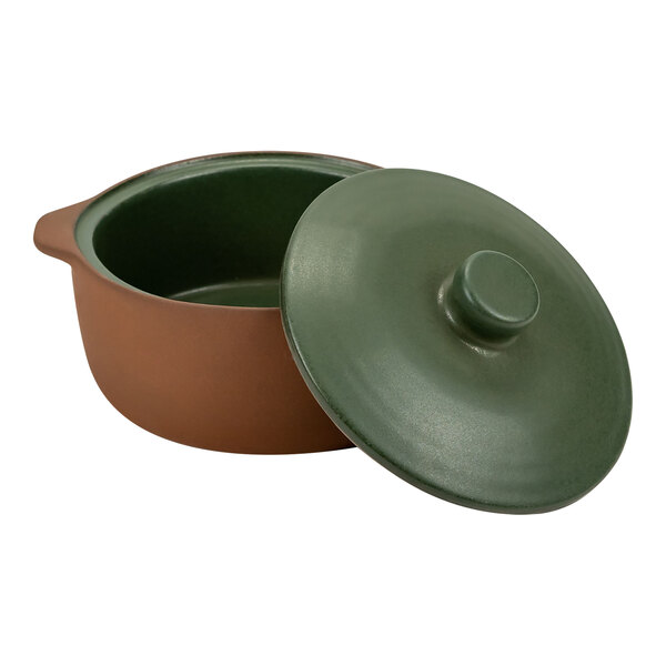 A brown terracotta casserole dish with a green lid.