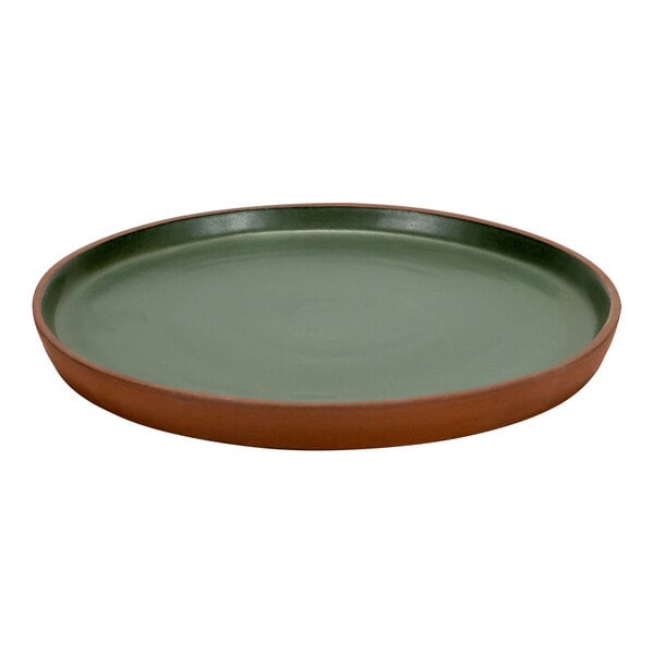 An Arcoroc green stoneware plate with a brown rim.