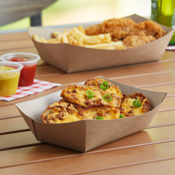 A Southern Champion paper food tray with food in a box on a table.