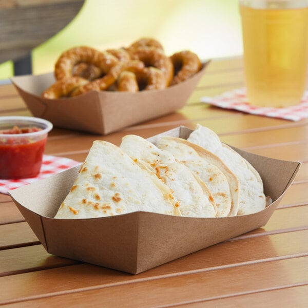 A table with a Southern Champion paper food tray filled with food.