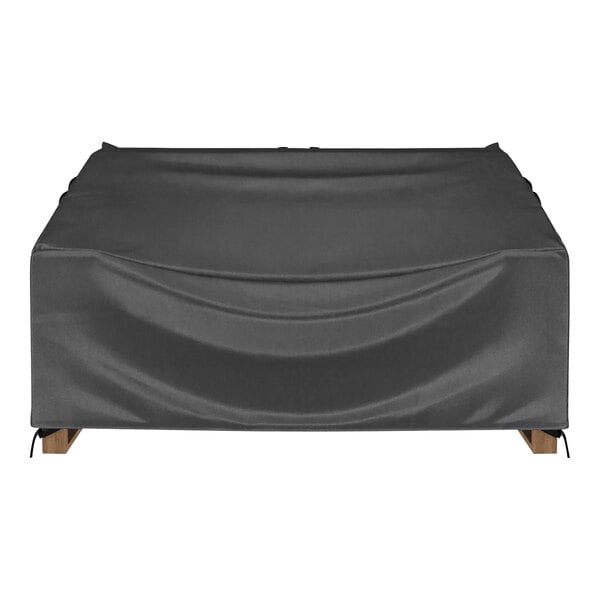 A black protective cover on a love seat sofa.