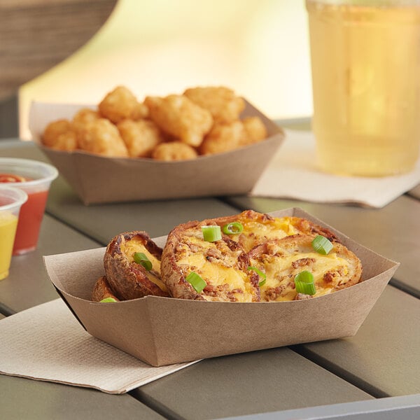 A Southern Champion paper food tray with a baked potato, tater tots, and a drink.