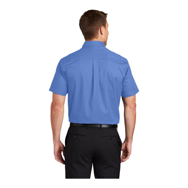 A man wearing a Port Authority ultramarine blue short sleeve dress shirt.