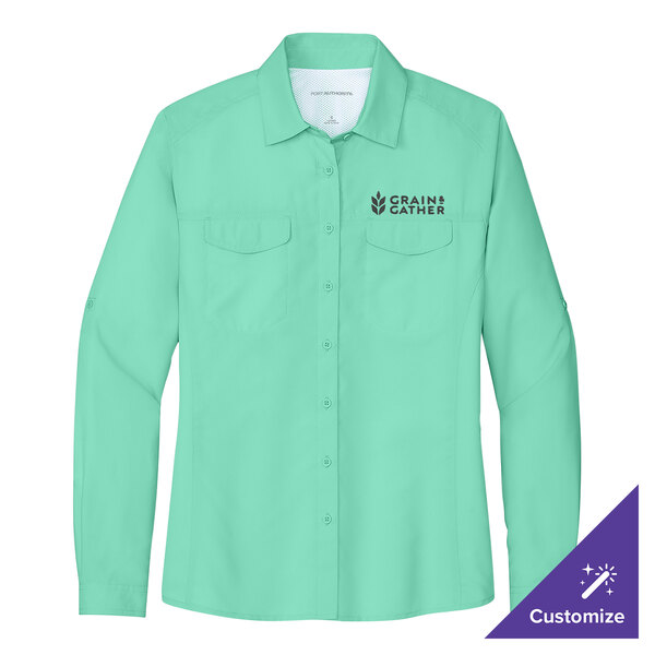 A bright seafoam green Port Authority long sleeve shirt with a logo on the chest.