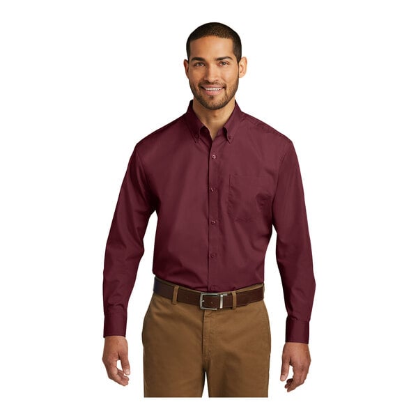 A man wearing a Port Authority burgundy long sleeve poplin dress shirt.