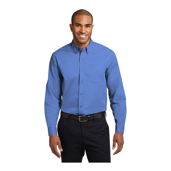 A man wearing a Port Authority long sleeve ultramarine blue poplin shirt.