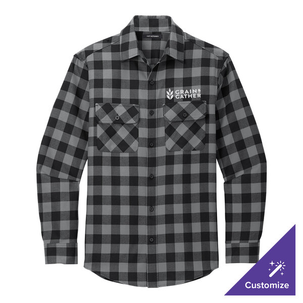 A close up of the pocket on a gray and black Buffalo check long sleeve flannel shirt.