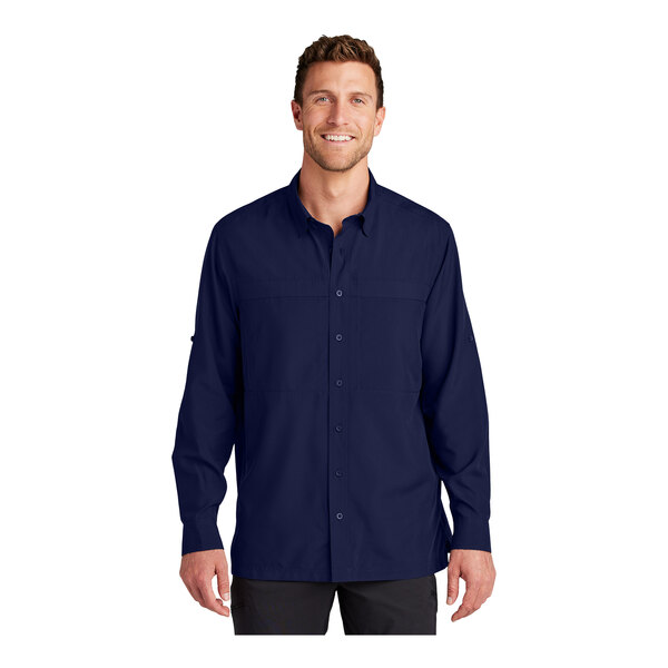 A man wearing a navy blue long sleeve Port Authority shirt.