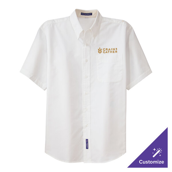 A white Port Authority dress shirt with gold embroidery on the chest.