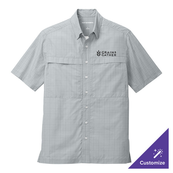 A silver and gray Port Authority short sleeve shirt with a logo on the chest.
