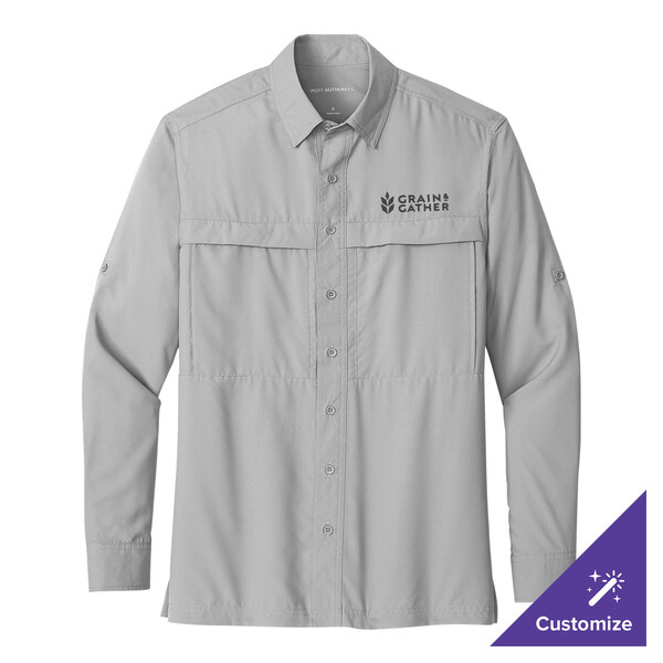 A Port Authority long sleeve shirt in gray with a logo on the chest.