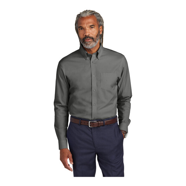 A man with grey hair and a beard wearing a Brooks Brothers deep black long sleeve dress shirt.