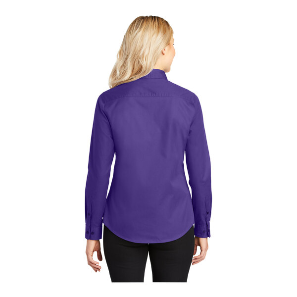 A woman wearing a purple and light stone Port Authority dress shirt.