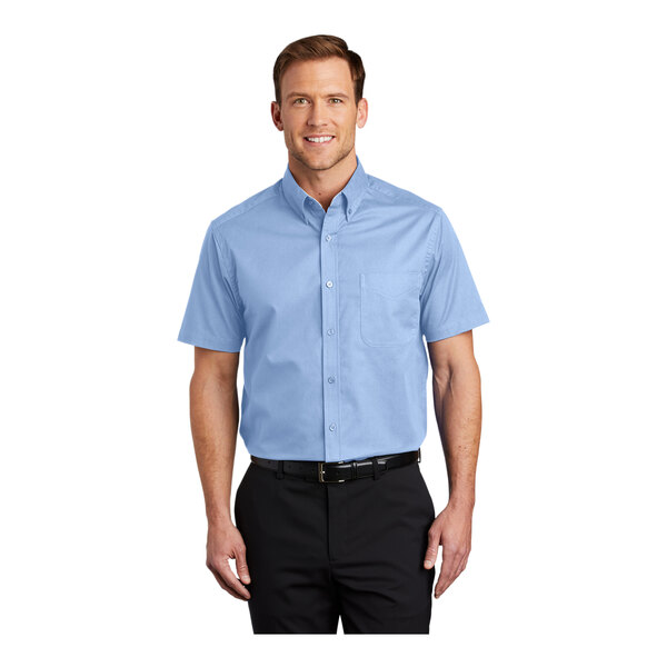 A man wearing a light blue Port Authority dress shirt with light stone accents.