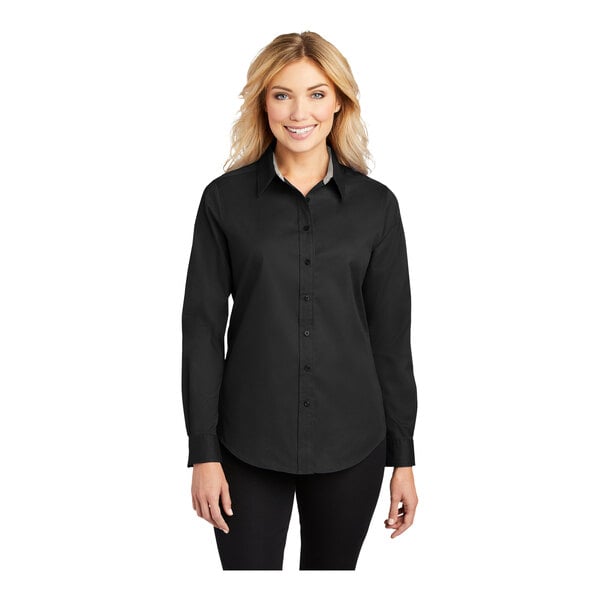 A woman wearing a black and light stone Port Authority long sleeve dress shirt.