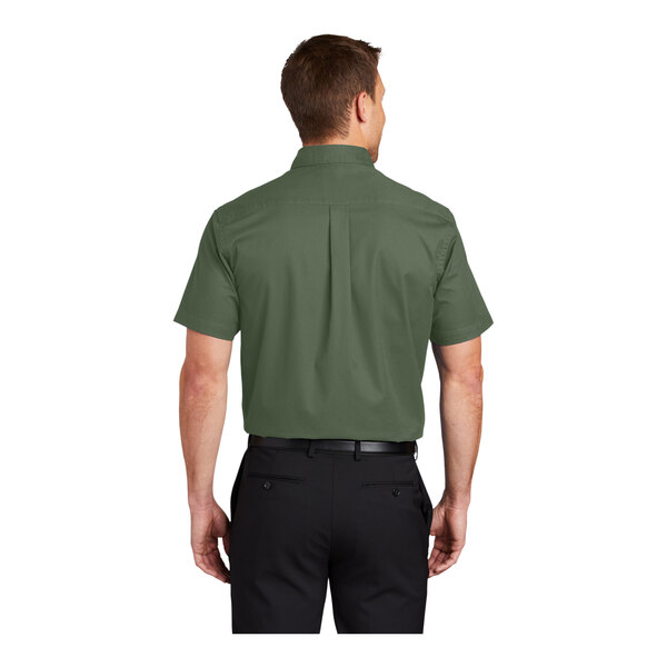 A man wearing a Port Authority short sleeve green dress shirt.