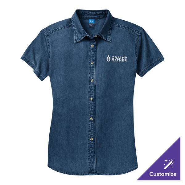 A Port & Company women's ink blue denim button-down shirt with white text on the front.