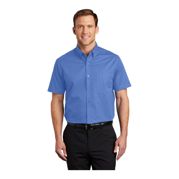 A man wearing an ultramarine blue Port Authority short sleeve dress shirt.