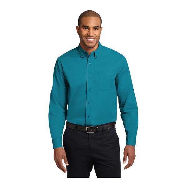 A man wearing a teal green Port Authority long sleeve dress shirt.