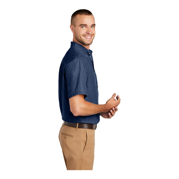 A man wearing an ink blue long sleeve denim button-down shirt.