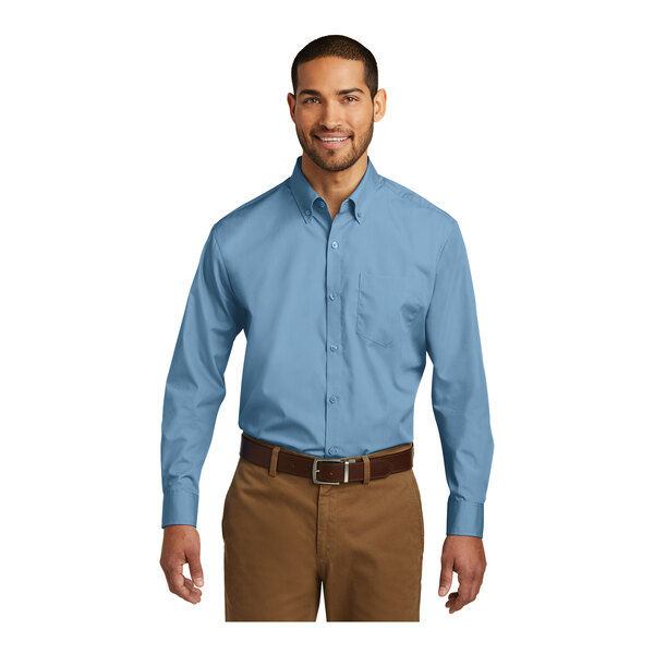 A man wearing a Port Authority long sleeve Carolina blue poplin dress shirt.