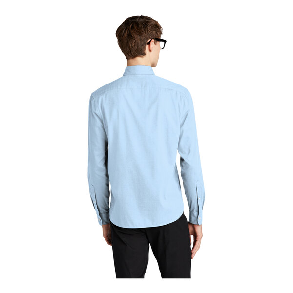 A man wearing a light blue Mercer+Mettle long sleeve dress shirt.