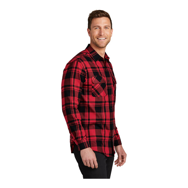 A man wearing a Port Authority red and black plaid flannel shirt.