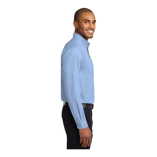 A man wearing a medium light blue Port Authority long sleeve dress shirt.