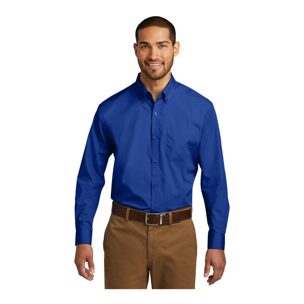 A man wearing a Port Authority long sleeve blue poplin dress shirt.