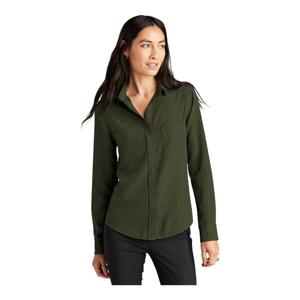 A woman wearing a Mercer+Mettle green long sleeve camp blouse.