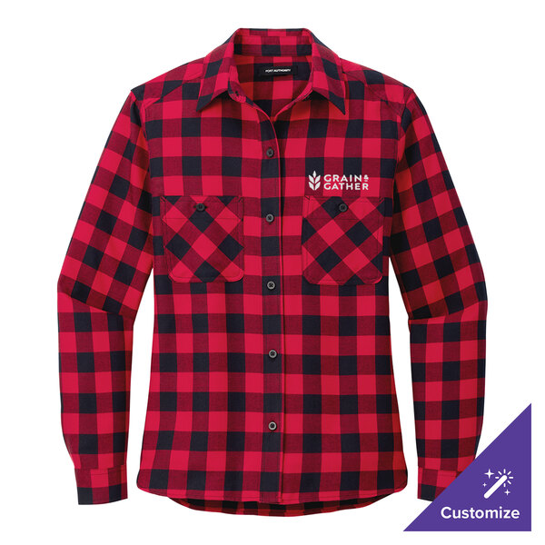 A red and black plaid Port Authority women's flannel shirt on a table.