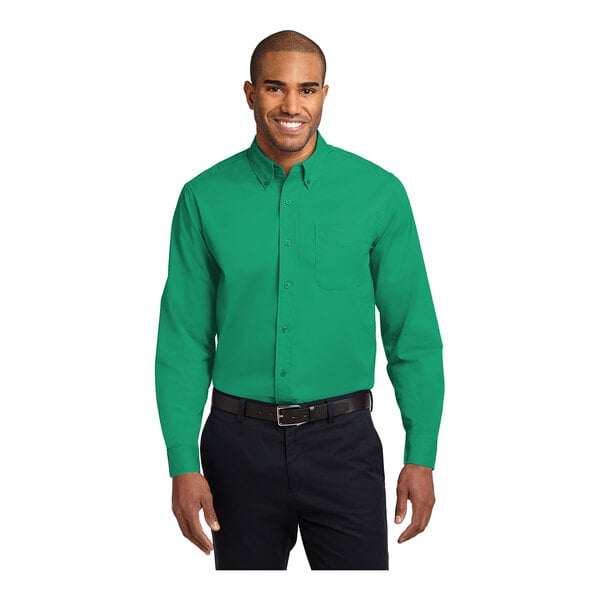 A man wearing a Port Authority court green long sleeve dress shirt.