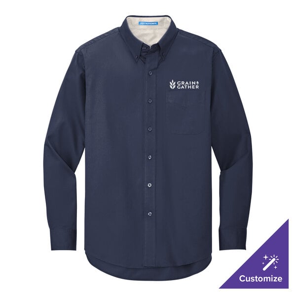 A Port Authority navy long sleeve dress shirt with a logo on the chest in light blue.