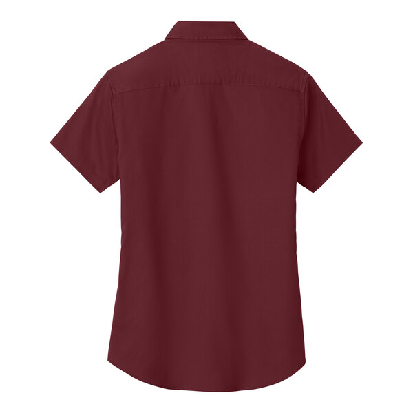 A Port Authority burgundy short sleeve dress shirt for women on a hanger.