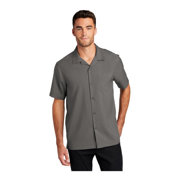 A man wearing a graphite grey Port Authority short sleeve staff shirt.