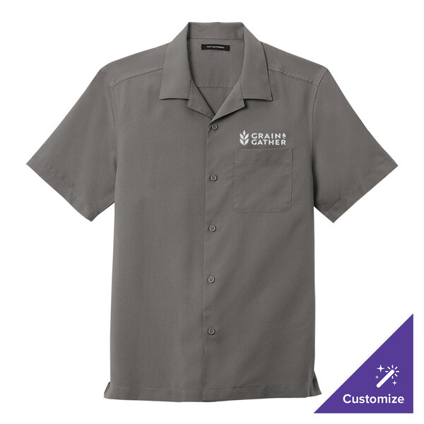 A graphite Port Authority short sleeve staff shirt with a logo on the chest.